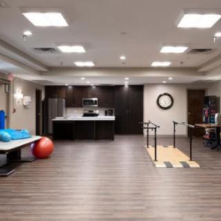 A modern rehabilitation and fitness room with exercise equipment.