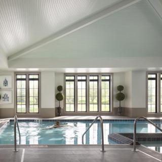 A luxurious indoor pool with elegant decor and ample natural light.