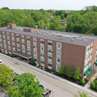 Aerial view of a residential apartment building surrounded by trees.