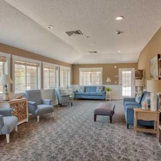 A spacious living room with ample seating and large windows allowing natural light.