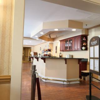 A welcoming reception area featuring a bar and wooden flooring.
