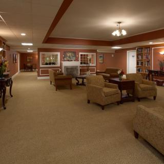 A spacious and elegantly furnished living room with multiple seating areas.