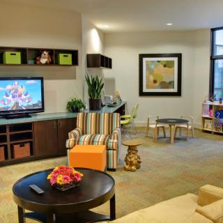 A modern living room featuring a television, stylish furniture, and tasteful decor.
