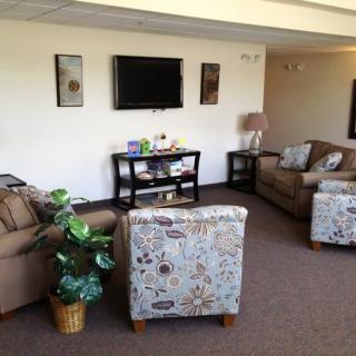 A cozy living room with couches, a television, and decorative elements.