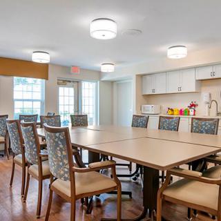 A modern conference room with a large table and chairs arranged for a meeting.