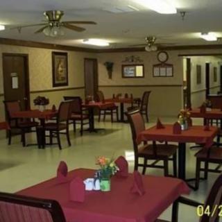 An empty dining area with neatly arranged tables and chairs.