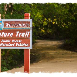 A sign marking the entrance to the Westshire Nature Trail, inviting visitors to explore the scenic pathway.