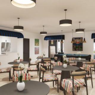 A modern restaurant interior featuring neatly arranged tables and chairs, with stylish lighting fixtures.