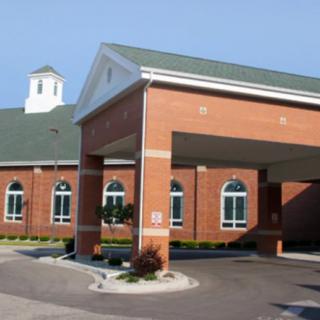 A brick building with a covered entrance canopy.