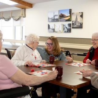 Seniors enjoying a game of bingo together in a lively community setting.