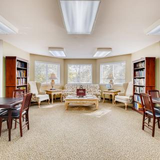 A cozy library reading area with comfortable seating and ample natural light.