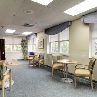 A bright and inviting waiting room with comfortable seating and ample natural light.