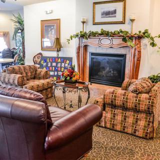 A cozy living room featuring a fireplace and comfortable seating arrangements.