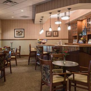Cozy restaurant interior with tables and chairs arranged for dining.