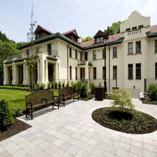 A historic villa surrounded by a landscaped garden.