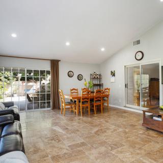 Spacious living and dining area with tile flooring and wide sliding glass doors for natural light.