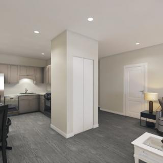 A modern open-layout apartment interior featuring a kitchen and living area.
