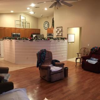 A cozy living room with an open kitchen and comfortable seating.