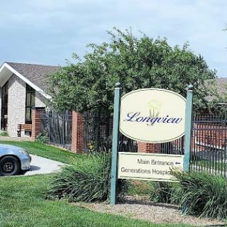 A welcoming entrance to a residential community, featuring well-maintained landscaping and signage.