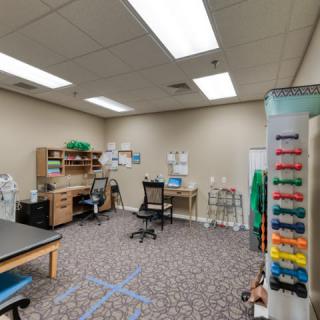 An organized office space with desks, chairs, and computer equipment.