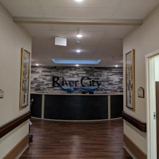 A view of the River City reception area, showcasing modern decor and a welcoming ambiance.