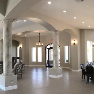 Spacious and elegant lobby with columns and modern lighting.