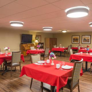 A cozy dining area set up with red tablecloths, ready for guests.