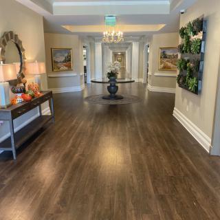 A beautifully decorated hallway with wooden floors and elegant furnishings.