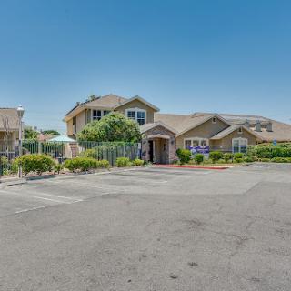 A view of a well-maintained residential building on a sunny day.