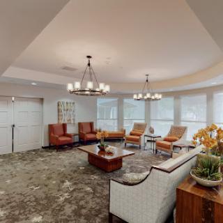 A cozy and modern lounge area featuring stylish seating and elegant lighting.