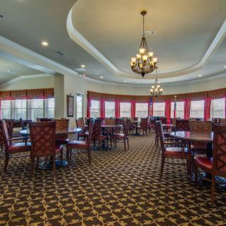 Spacious dining area with elegant decor and lighting.