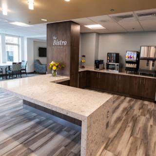 A modern reception area featuring a stylish countertop and comfortable seating.