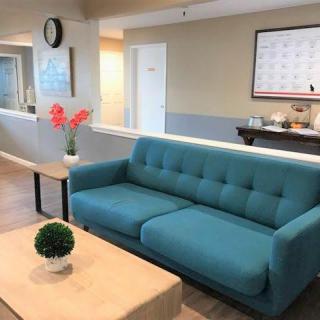 A cozy living room with a blue sofa and decorative elements, creating a modern and inviting atmosphere.