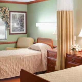 A cozy bedroom with twin beds, warm lighting, and elegant decor.
