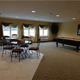 A cozy games room featuring a pool table and seating area.