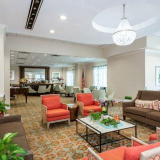 A modern lounge area with comfortable seating and bright lighting.