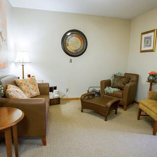 A cozy living room with comfortable seating and elegant decor.