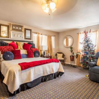 Cozy bedroom with festive Christmas decorations and colorful pillows.