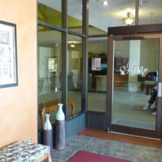 A lobby entrance with glass doors and decorative vases.