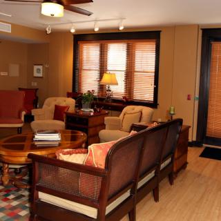 Cozy and warm living room interior with wooden flooring and comfortable seating.