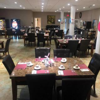 An empty restaurant dining area with tables set for service.