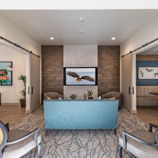 Modern lobby with seating area and decorative artwork.