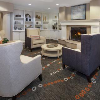 A cozy and modern living room with a fireplace and comfortable seating.