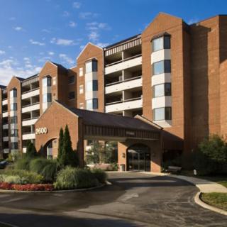 Exterior view of a modern hotel building with landscaped entrance.
