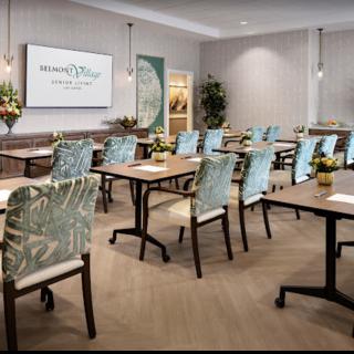 A well-arranged conference room with chairs and tables set for a meeting.