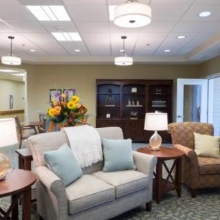 A cozy living room with comfortable seating and elegant lighting.
