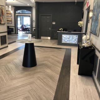 A modern lobby area with a reception desk and contemporary artwork.