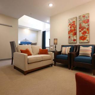 A cozy living room featuring comfortable seating and vibrant wall artwork.