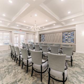 A modern conference room with neatly arranged chairs and elegant interior design.