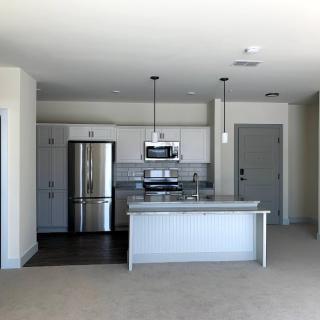 Modern kitchen with stainless steel appliances and an island counter.
